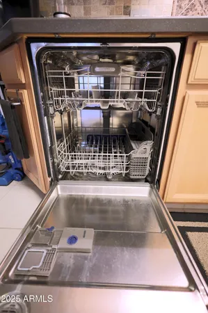 a stove top oven sitting inside of a kitchen and granite counter tops