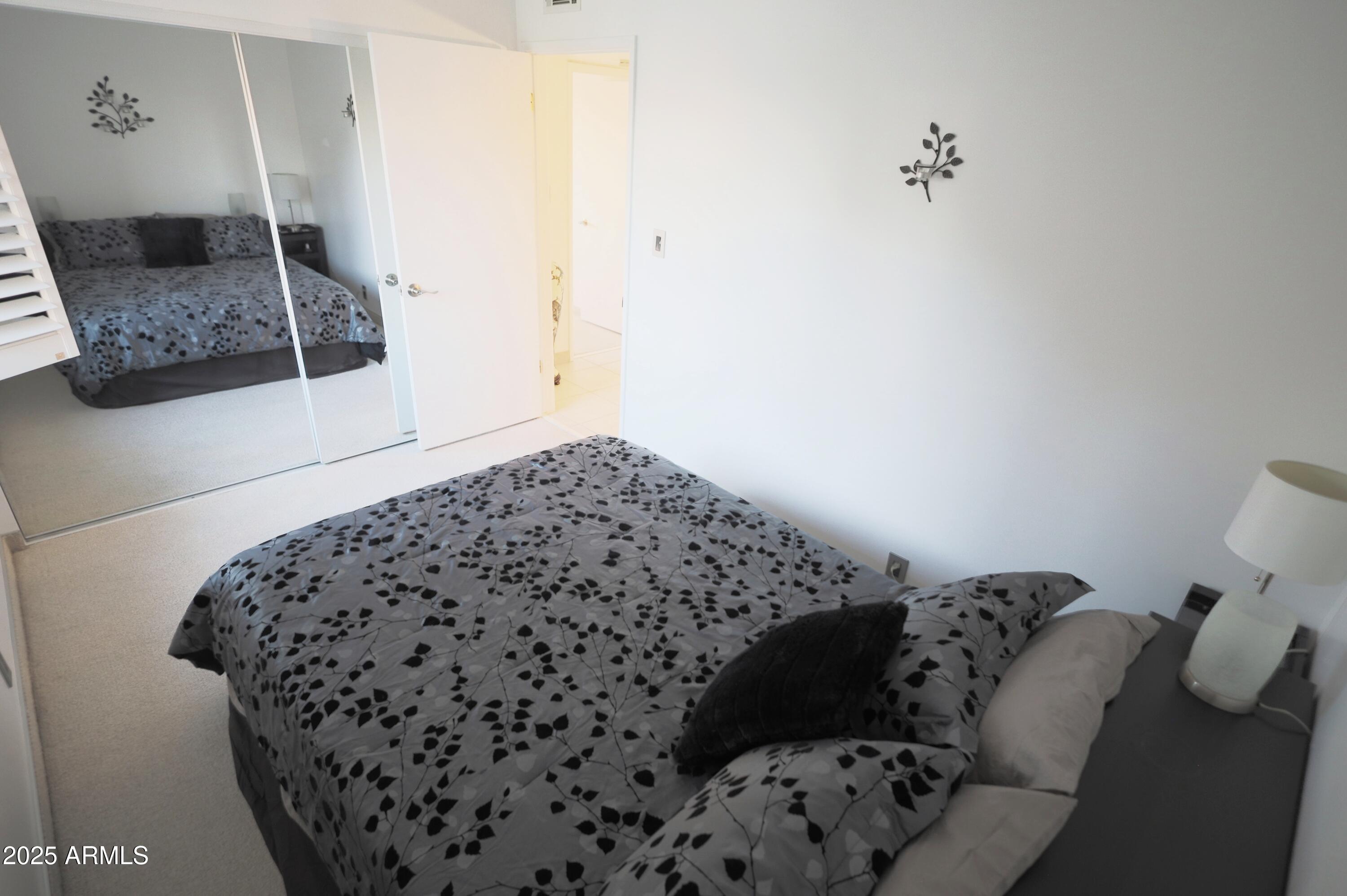 7820 East Camelback Road, Unit 309 Scottsdale, AZ 85251 - Photo 24 of 55 a bedroom with a bed and a window