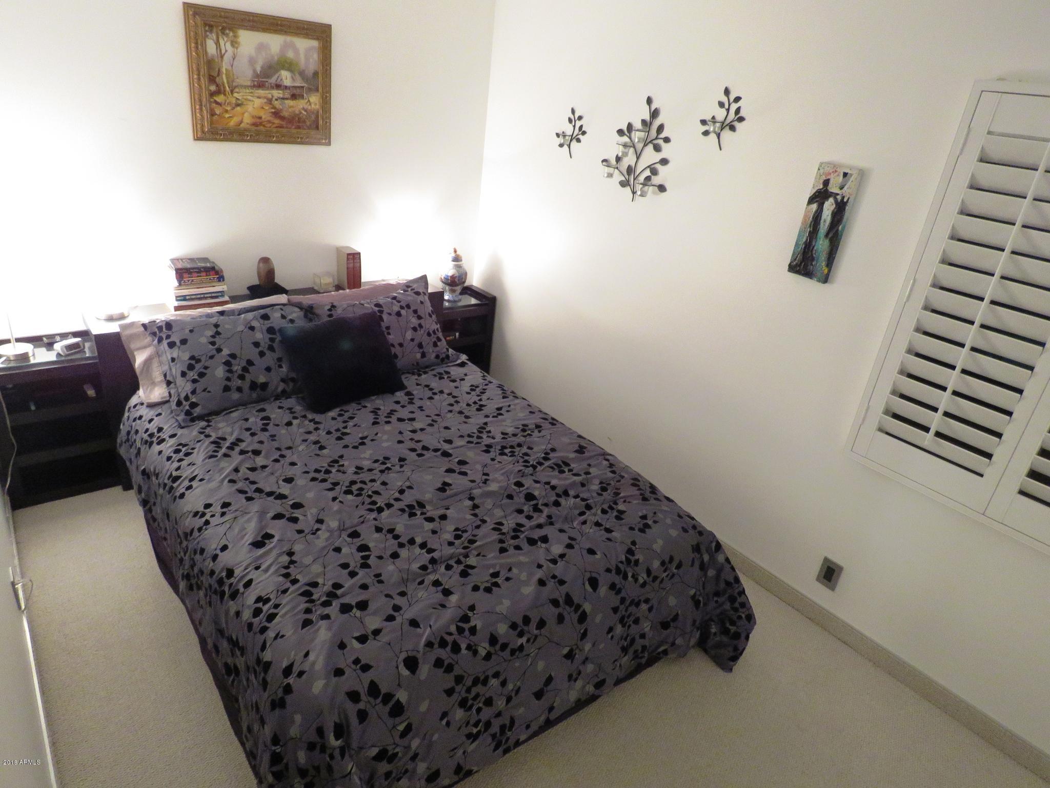 7820 East Camelback Road, Unit 309 Scottsdale, AZ 85251 - Photo 25 of 55 a bedroom with a bed and a wall painting