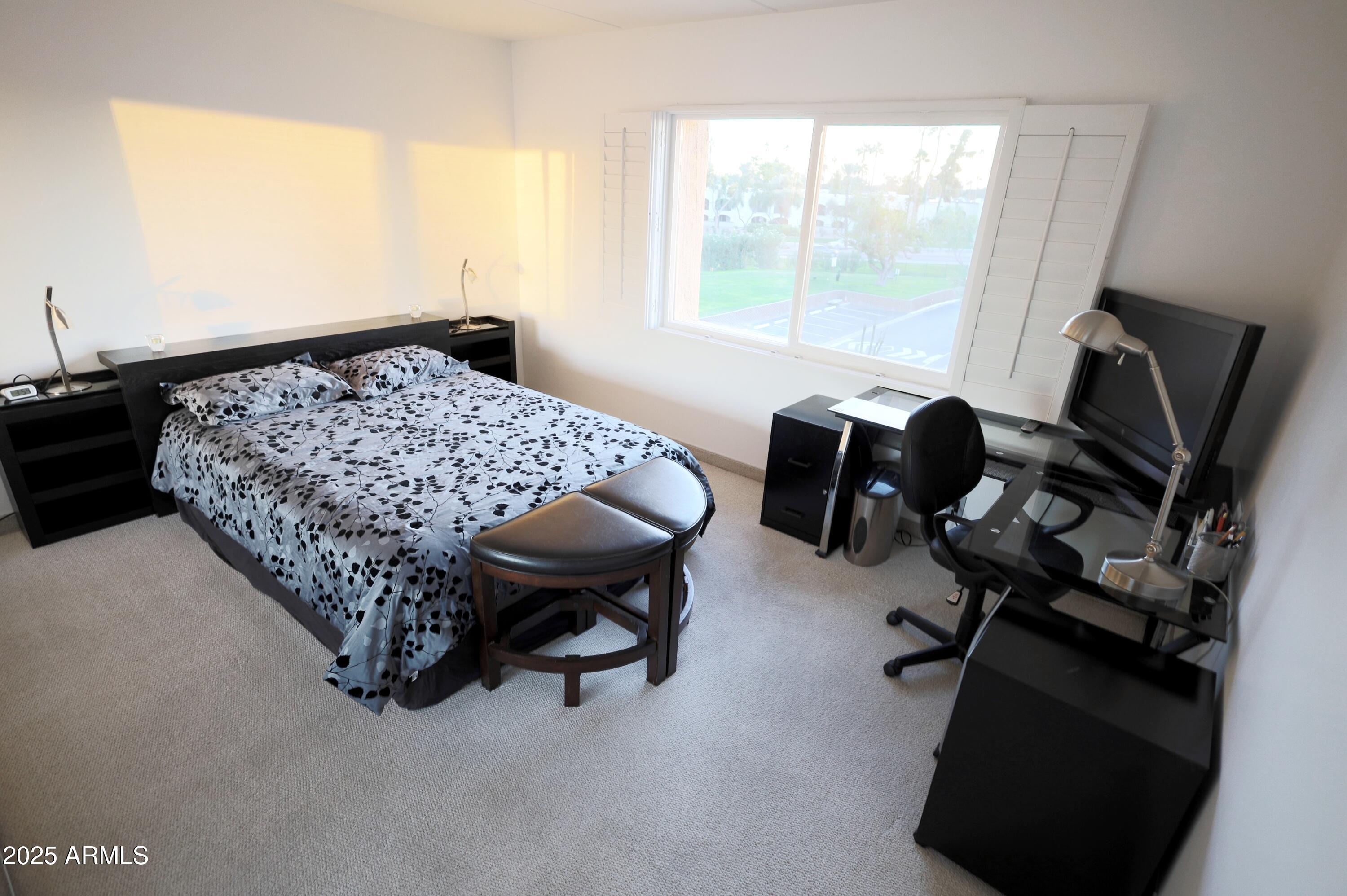 7820 East Camelback Road, Unit 309 Scottsdale, AZ 85251 - Photo 28 of 55 a bedroom with furniture and a large window