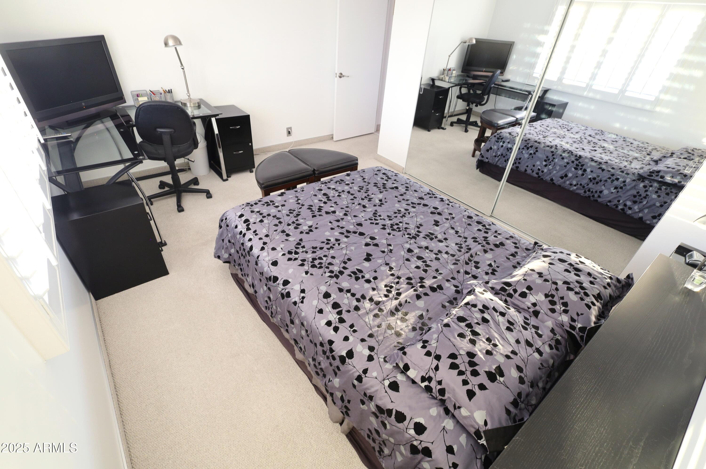 7820 East Camelback Road, Unit 309 Scottsdale, AZ 85251 - Photo 29 of 55 a bedroom with bed and wooden floor