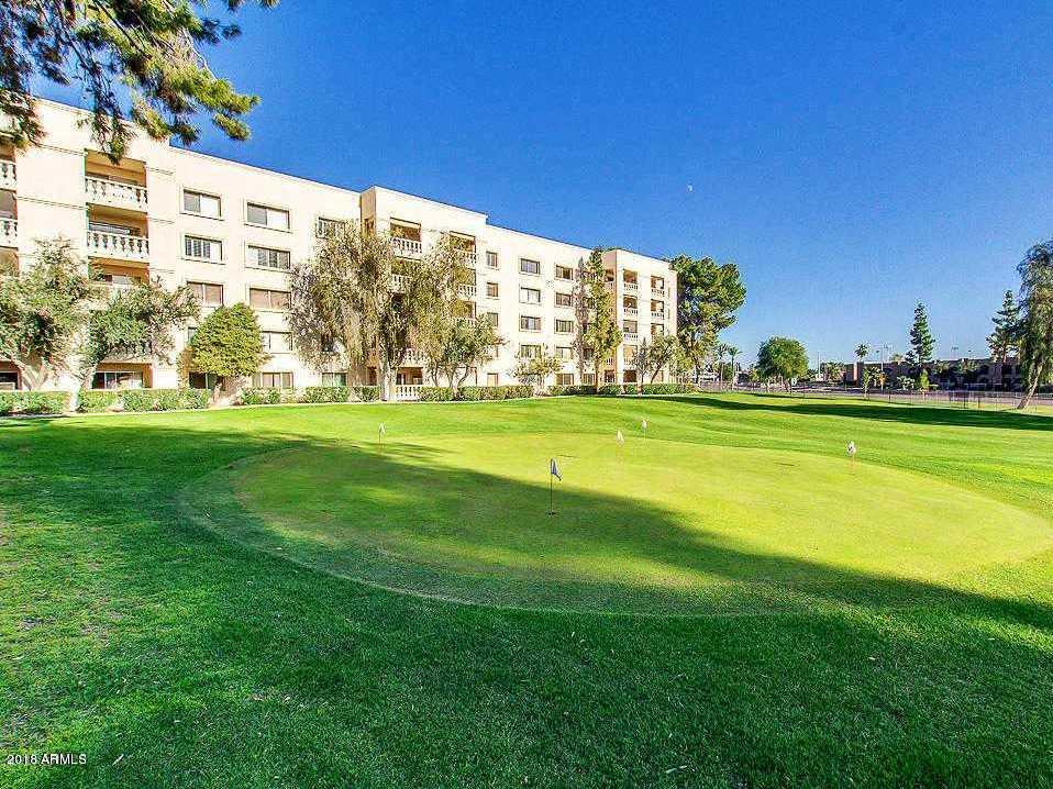 7820 East Camelback Road, Unit 309 Scottsdale, AZ 85251 - Photo 48 of 55 a view of a building with a big yard and large trees