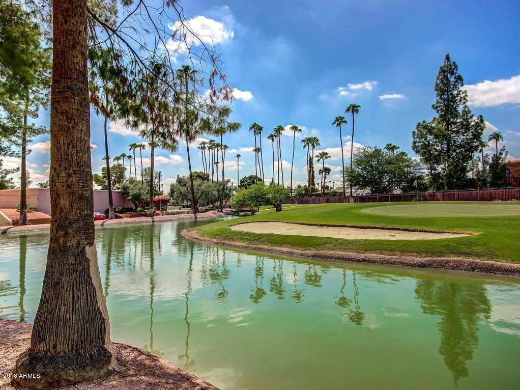 7820 East Camelback Road, Unit 309 Scottsdale, AZ 85251 - Photo 49 of 55 a view of a lake with a building in the background