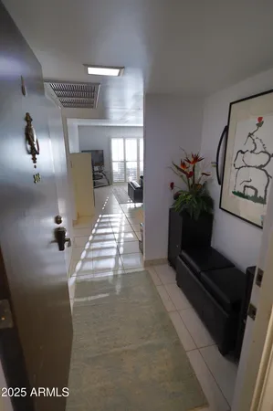 a lobby with furniture and potted plants