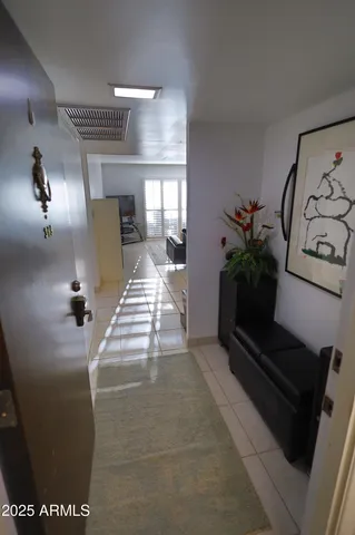 a lobby with furniture and potted plants