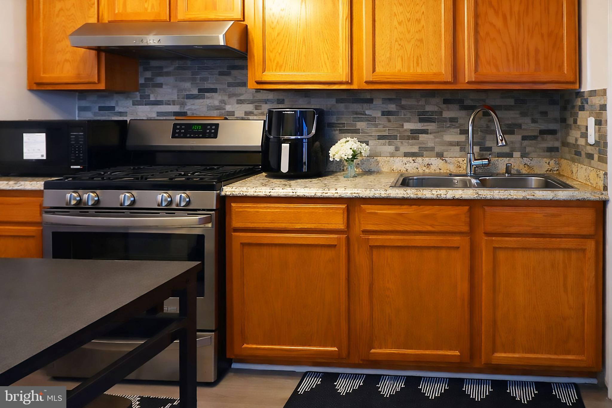 3935 Clay Place Northeast Washington, DC 20019 - Photo 5 of 17 a kitchen with granite countertop cabinets stainless steel appliances and a counter space