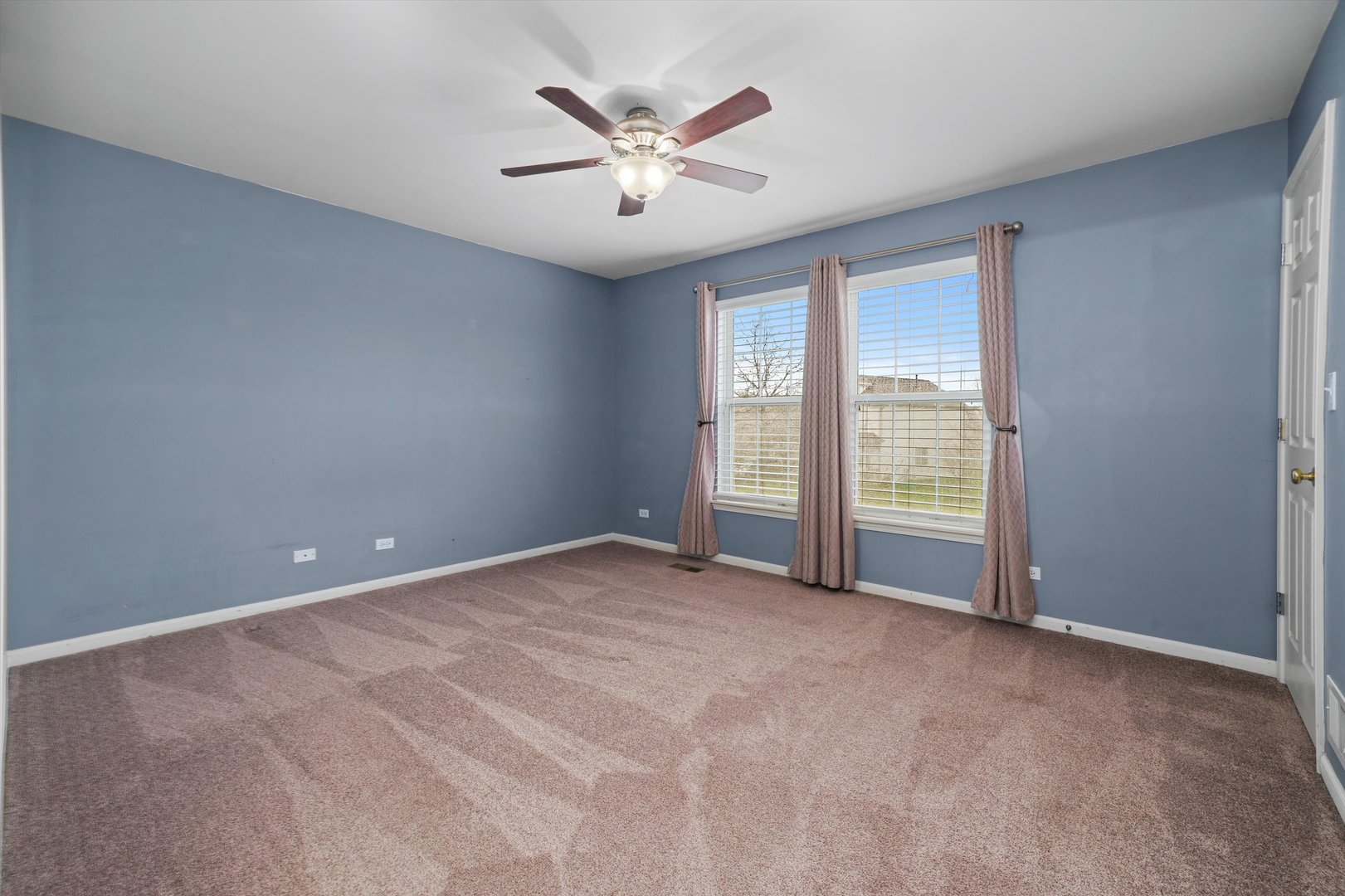 790 Montclair Drive Round Lake, IL 60073 - Photo 12 of 21 an empty room with windows and fan