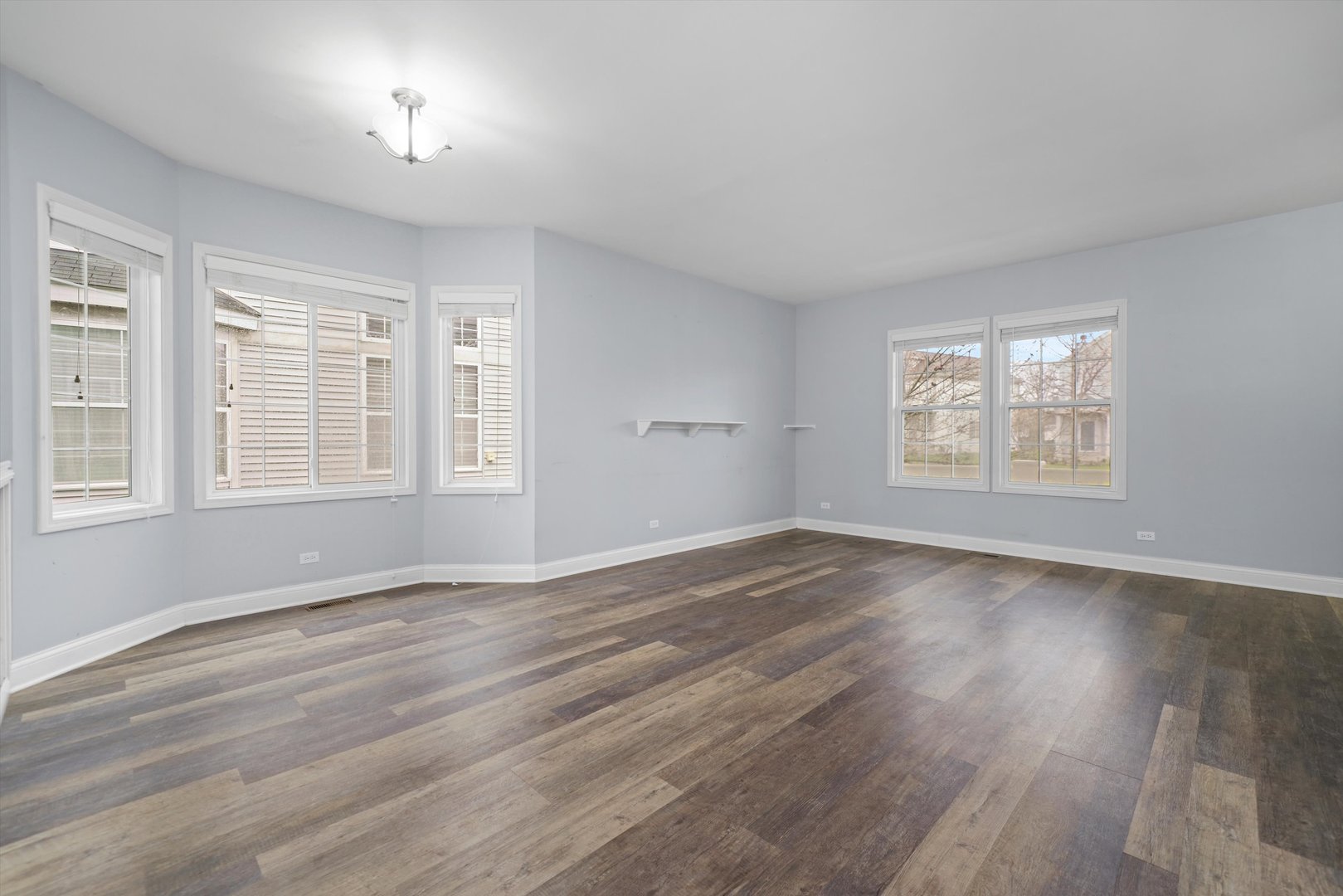 790 Montclair Drive Round Lake, IL 60073 - Photo 4 of 21 a view of an empty room with wooden floor and a window