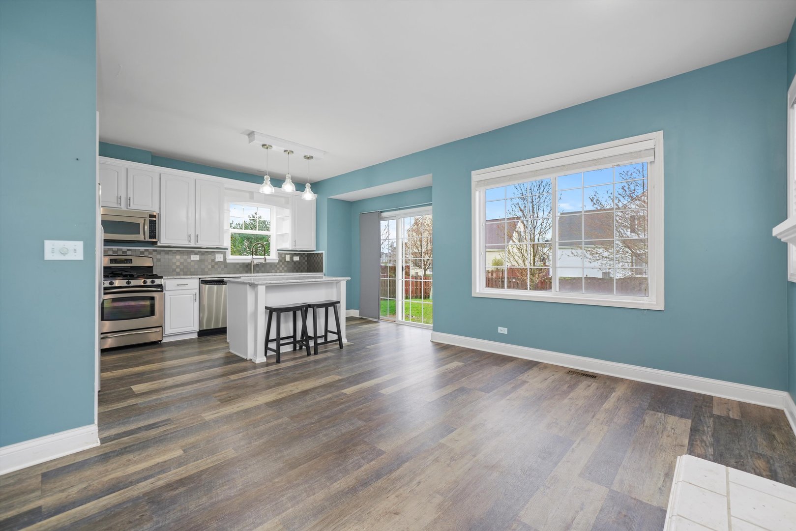 790 Montclair Drive Round Lake, IL 60073 - Photo 6 of 21 a kitchen with stainless steel appliances granite countertop a stove top oven a sink and dishwasher with wooden floor