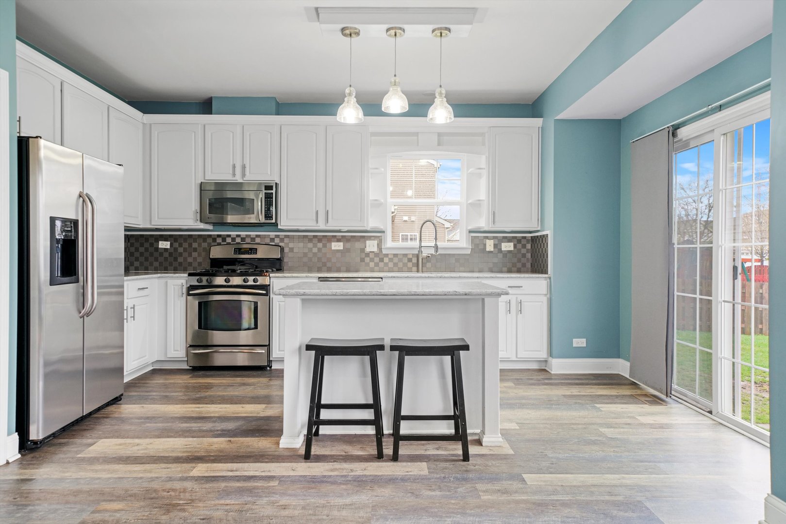 790 Montclair Drive Round Lake, IL 60073 - Photo 7 of 21 a kitchen with kitchen island granite countertop a stove a sink and a refrigerator