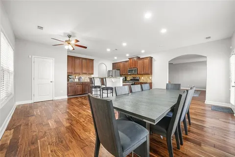 a view of a dining room with furniture and wooden floor