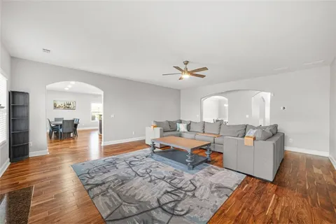 a living room with furniture and wooden floor