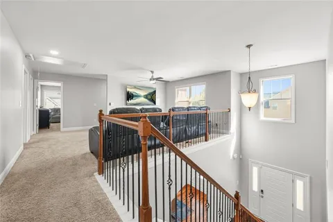 a living room with furniture and a ceiling fan