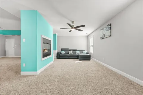 a bathroom with a granite countertop sink a light fixture and a mirror