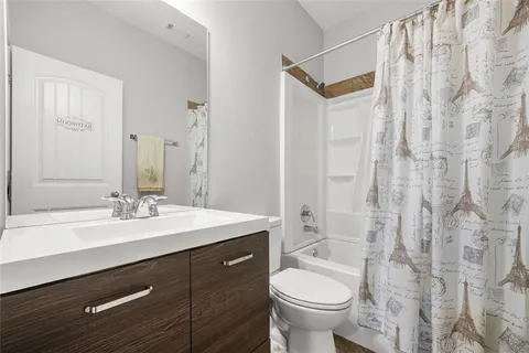 a spacious bedroom with a bed and a chandelier