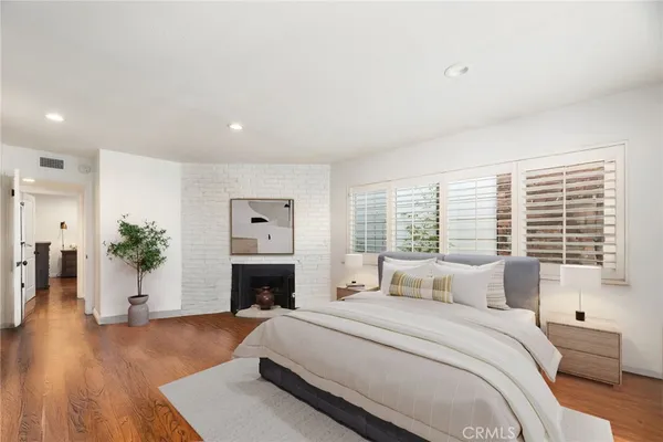 a spacious bedroom with a large bed and a fireplace