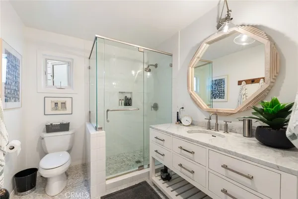 a bathroom with a toilet a sink and a mirror
