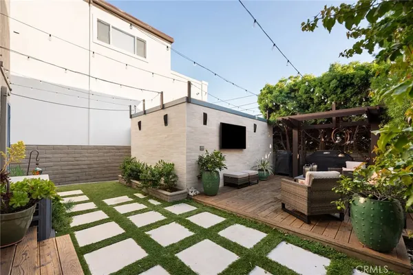 a view of a patio with table and chairs potted plants