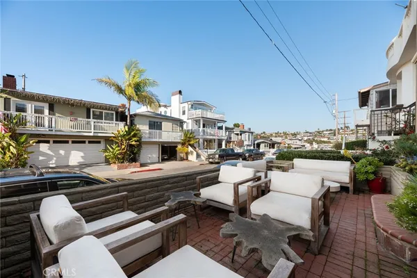 a view of a patio with couches table and chairs with potted plants