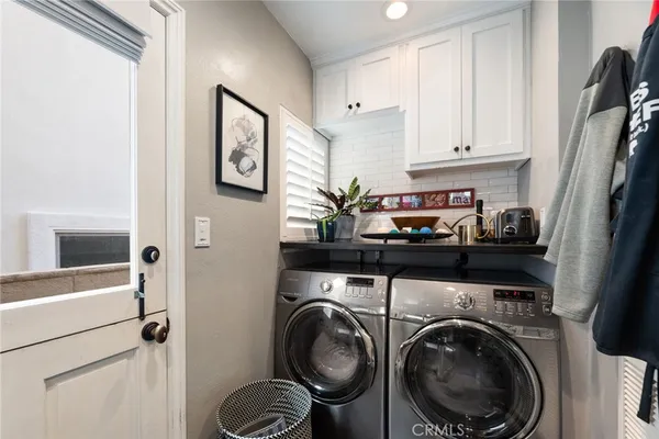 a close view of a utility room with sink dryer and washer