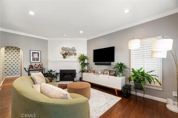a living room with fireplace furniture and a flat screen tv