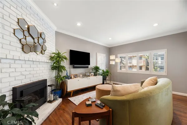 a living room with furniture a flat screen tv and a fireplace