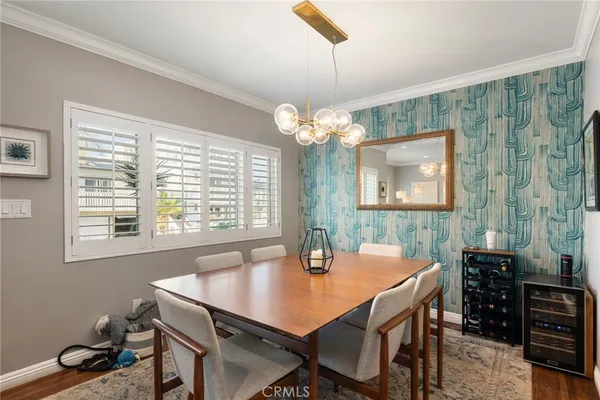 a view of a dining room with furniture and chandelier