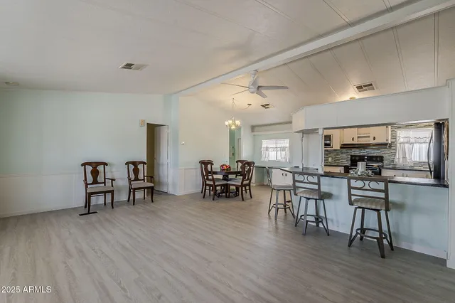a view of a dining room with furniture and wooden floor