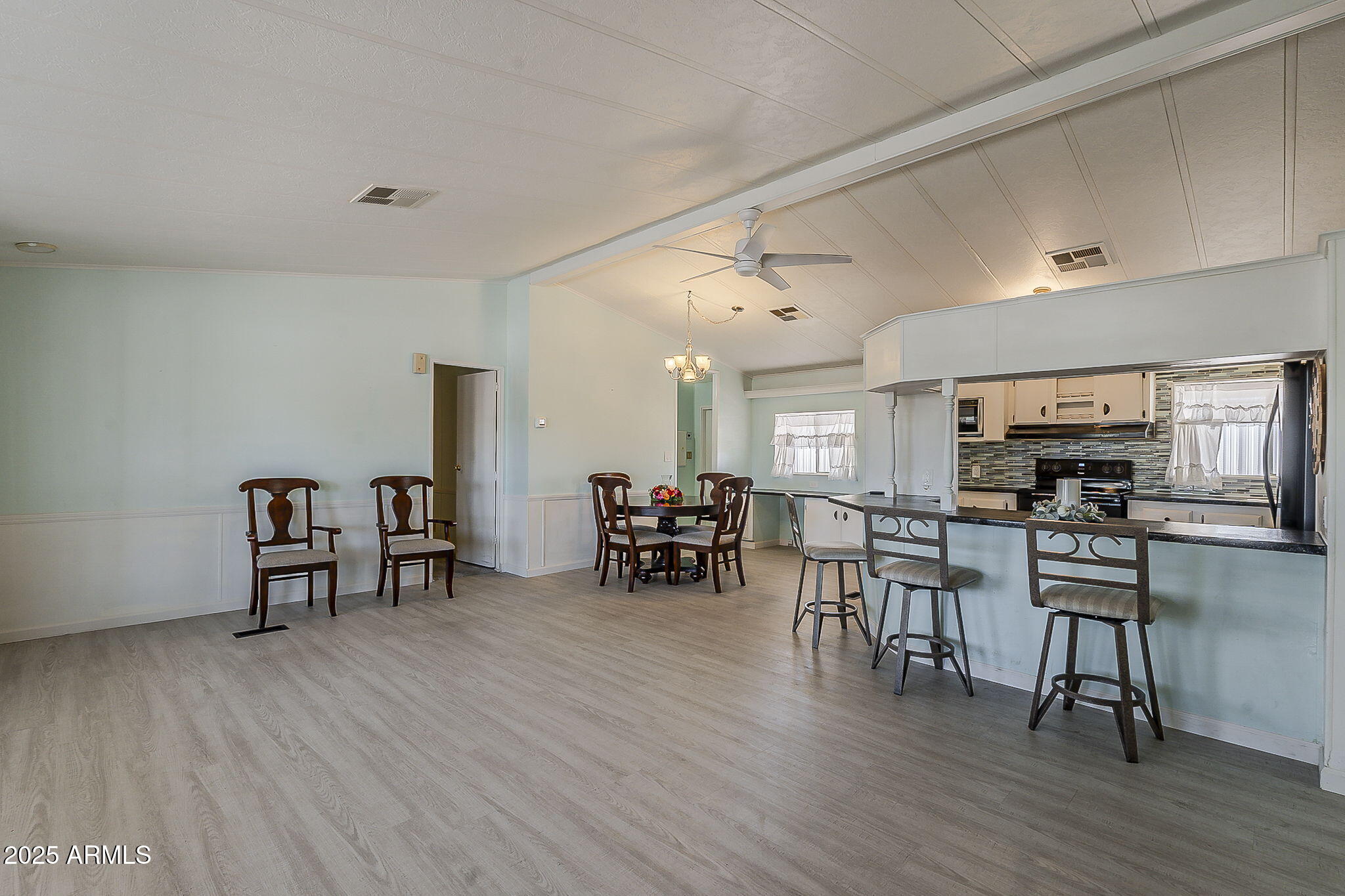 834 South Meridian Road, Unit 118 Apache Junction, AZ 85120 - Photo 12 of 43 a view of a dining room with furniture and wooden floor