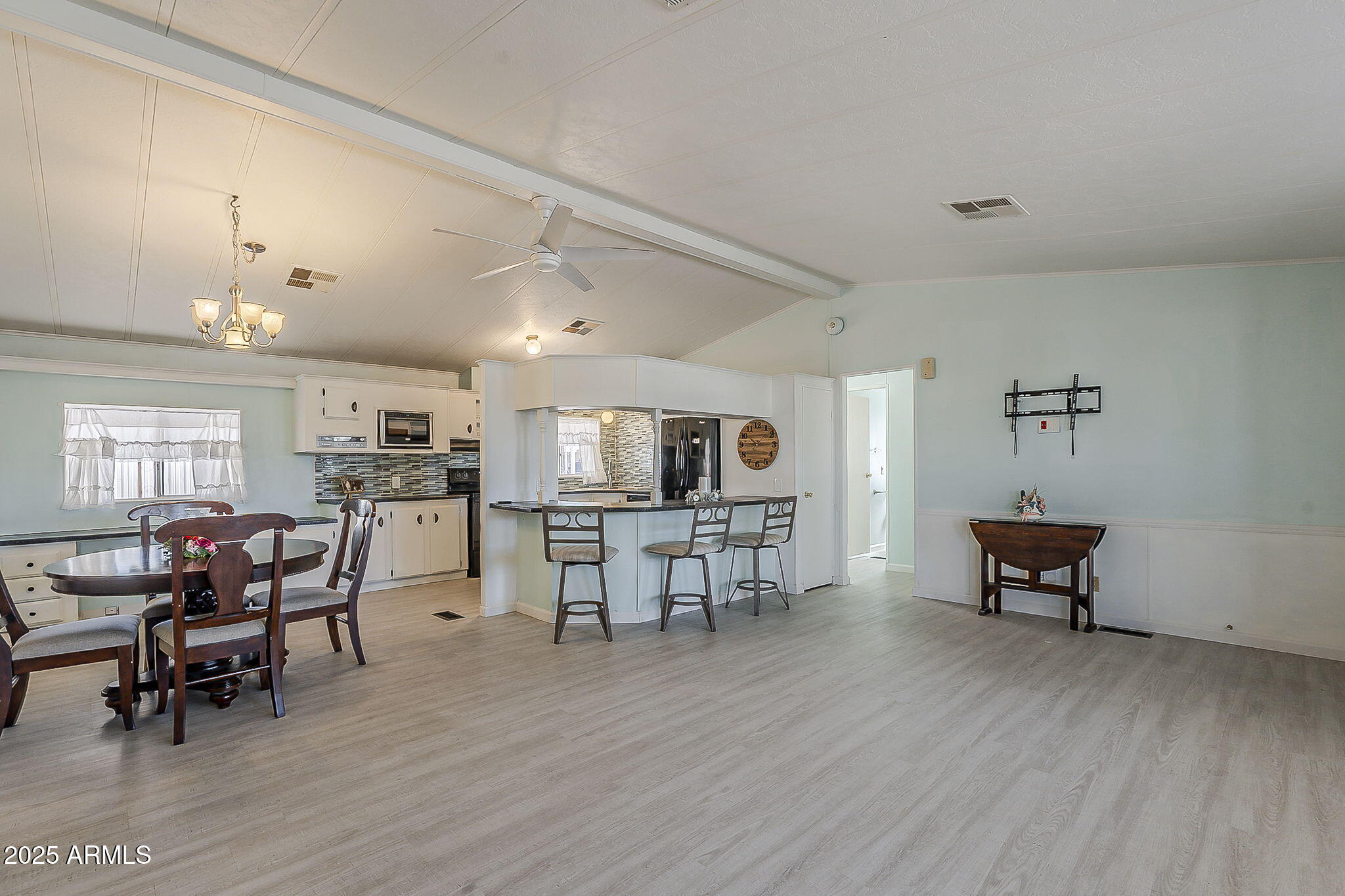 834 South Meridian Road, Unit 118 Apache Junction, AZ 85120 - Photo 13 of 43 a view of a dining room with furniture and wooden floor
