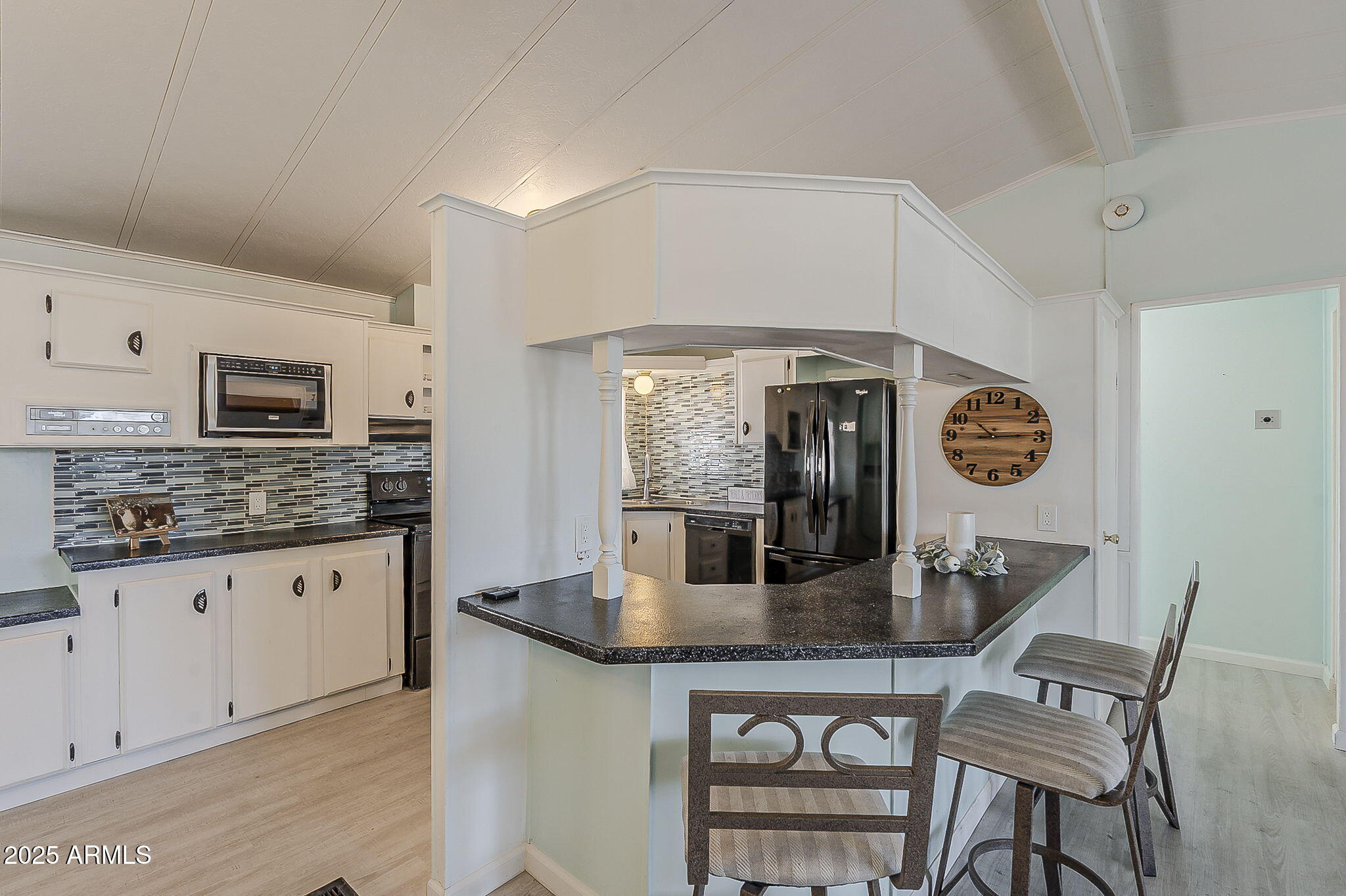 834 South Meridian Road, Unit 118 Apache Junction, AZ 85120 - Photo 14 of 43 a kitchen with granite countertop stainless steel appliances a table chairs and a refrigerator