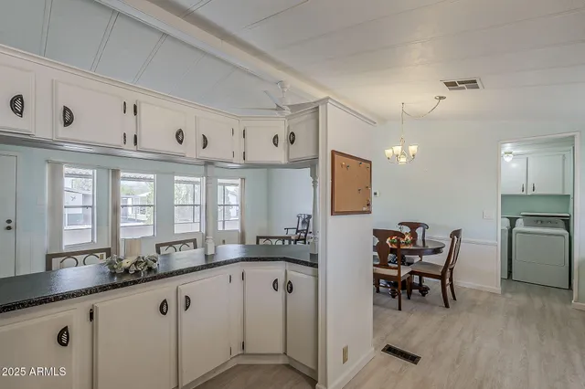 a large white kitchen with a large window