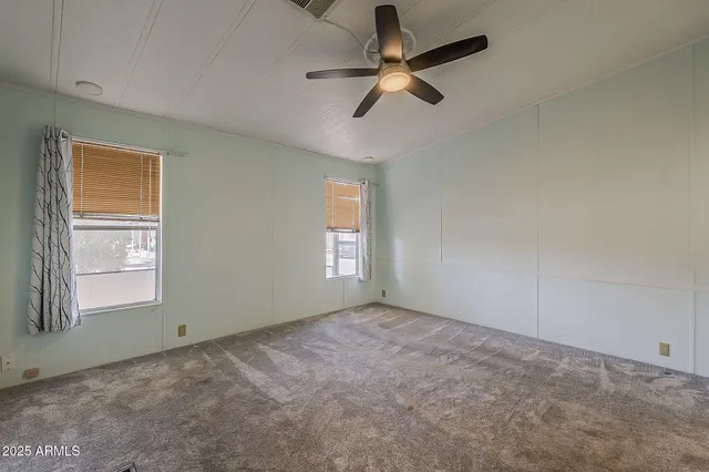 a bathroom with a granite countertop sink toilet and a mirror