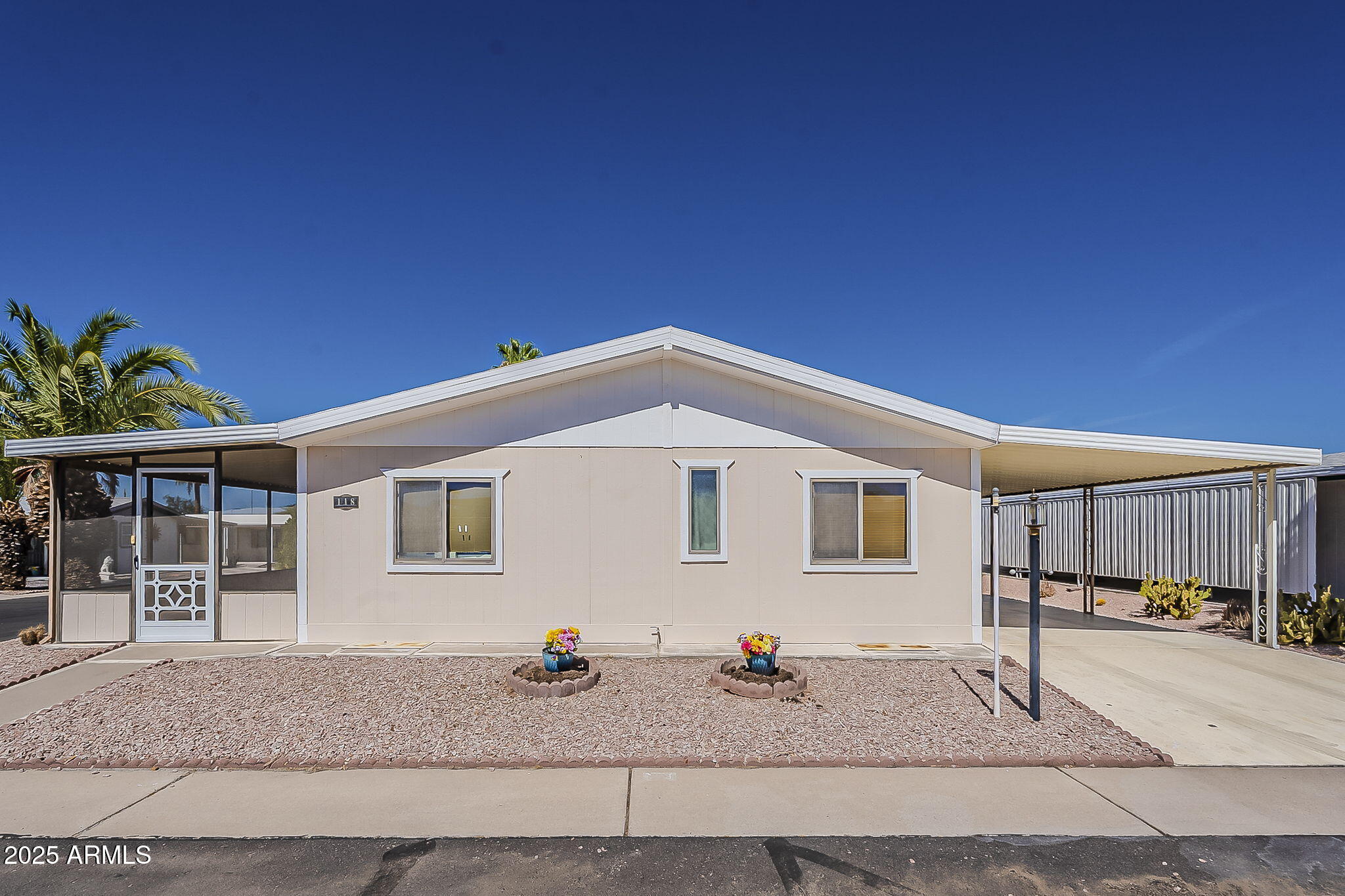 834 South Meridian Road, Unit 118 Apache Junction, AZ 85120 - Photo 3 of 43 a front view of a house with a garden and plants