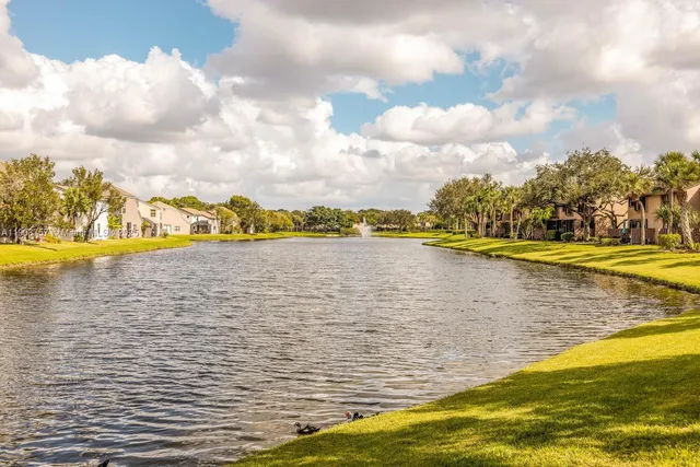 a view of a lake with houses in the back