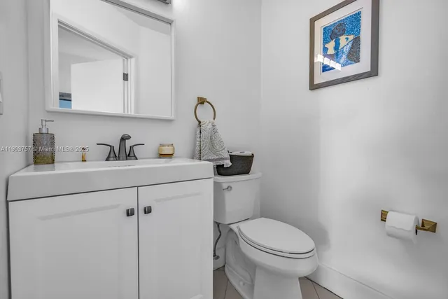 a bathroom with a toilet a sink and mirror