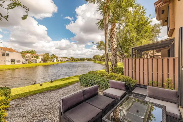 a view of a terrace with lawn chairs