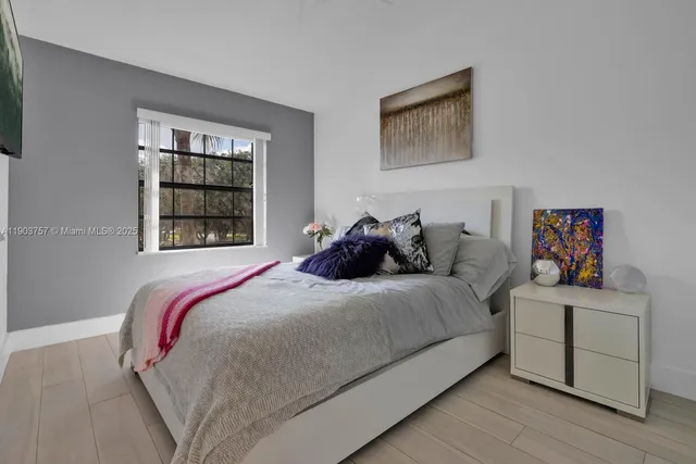 a bedroom with a bed and window