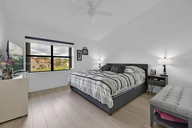 a spacious bedroom with a bed and a window