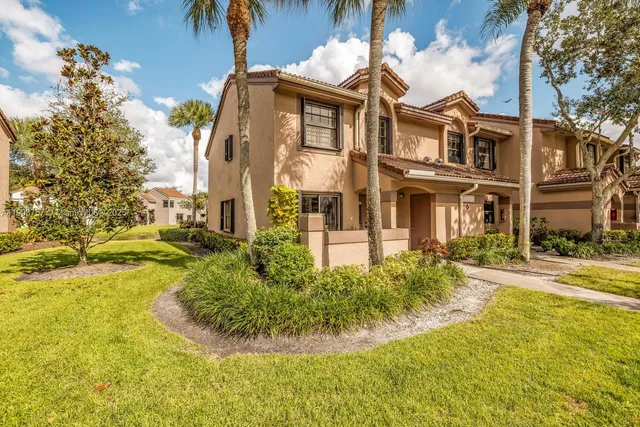 a view of a white house with a swimming pool