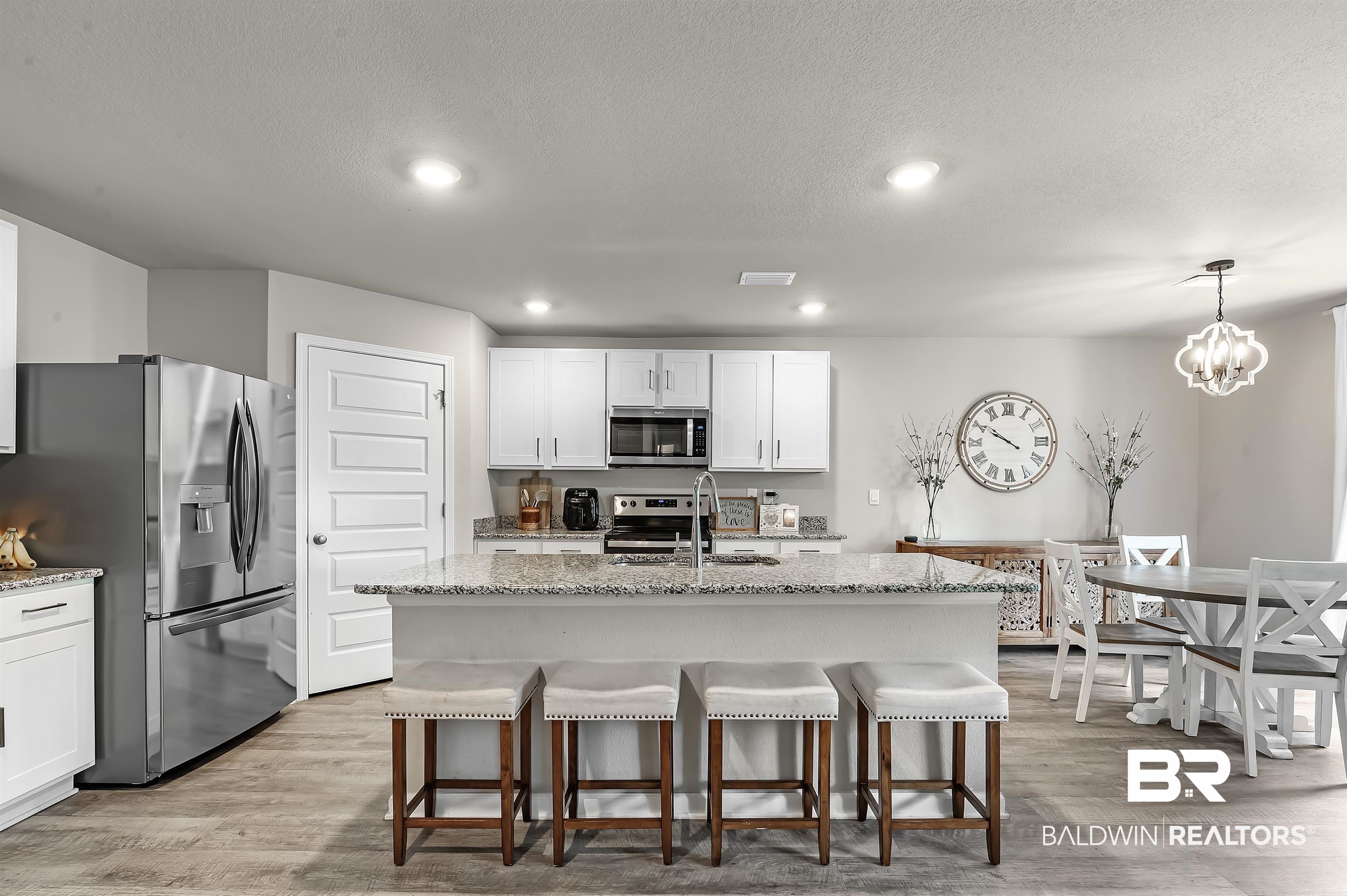 24549 Broken Sound Loop Orange Beach, AL 36561 - Photo 15 of 57 Kitchen featuring stainless steel appliances, hanging light fixtures, an island with sink, and sink