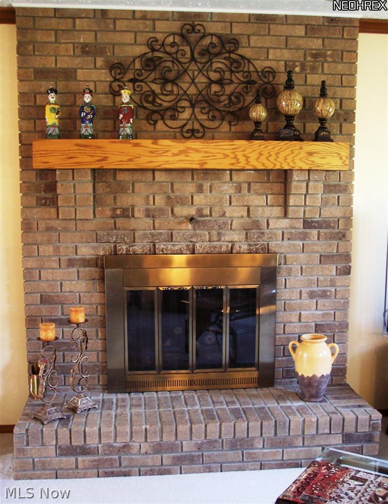 32965 Pettibone Road Solon, OH 44139 - Photo 11 of 25 Raised hearth gas fireplace with oak mantel.