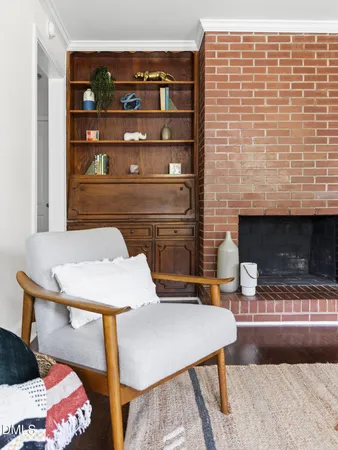 a living room with a table chairs and a fireplace
