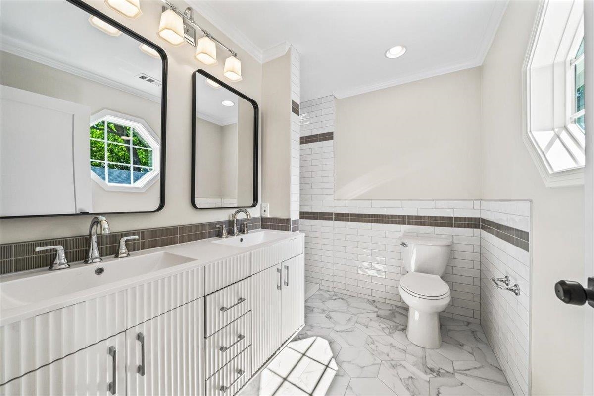 170 South Greer Street Memphis, TN 38111 - Photo 16 of 35 Dual vanity with fluted cabinetry and integrated sinks