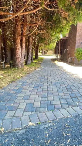 a view of a dirt road with a building in the background