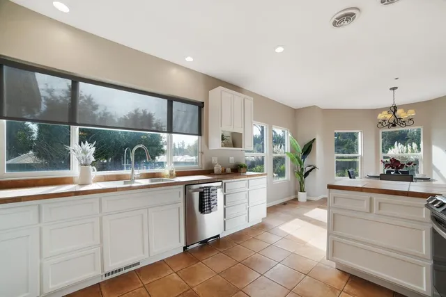 a view of a dining room with furniture large windows and wooden floor