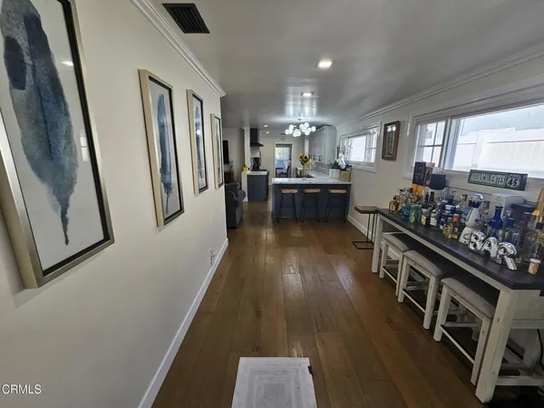 a kitchen with stainless steel appliances a refrigerator a sink dishwasher and wooden cabinets