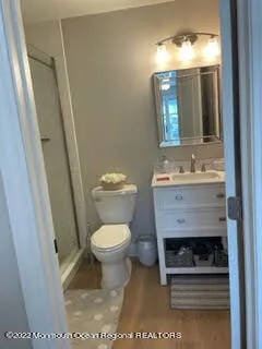 a bathroom with a sink toilet and mirror