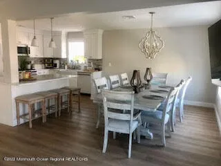 a view of a dining room with furniture wooden floor and chandelier