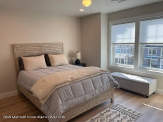 216 Eisenhower Avenue Seaside Heights, NJ 08751 - Photo 23 of 43 a bedroom with a bed and glass window